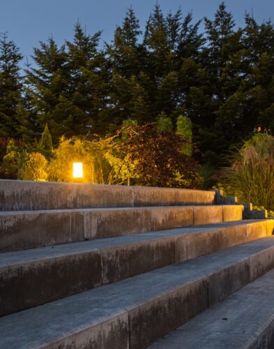 Large Garden Concrete Stairs and Illuminated Rockery Garden. Residential Architecture.