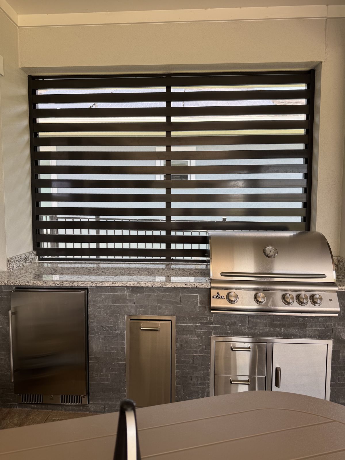Paver outdoor kitchen with grill and shade in Orlando FL